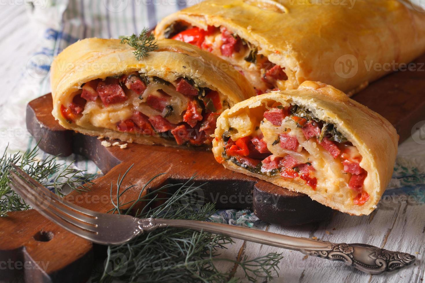 strudel with ham, cheese and vegetables closeup. horizontal photo