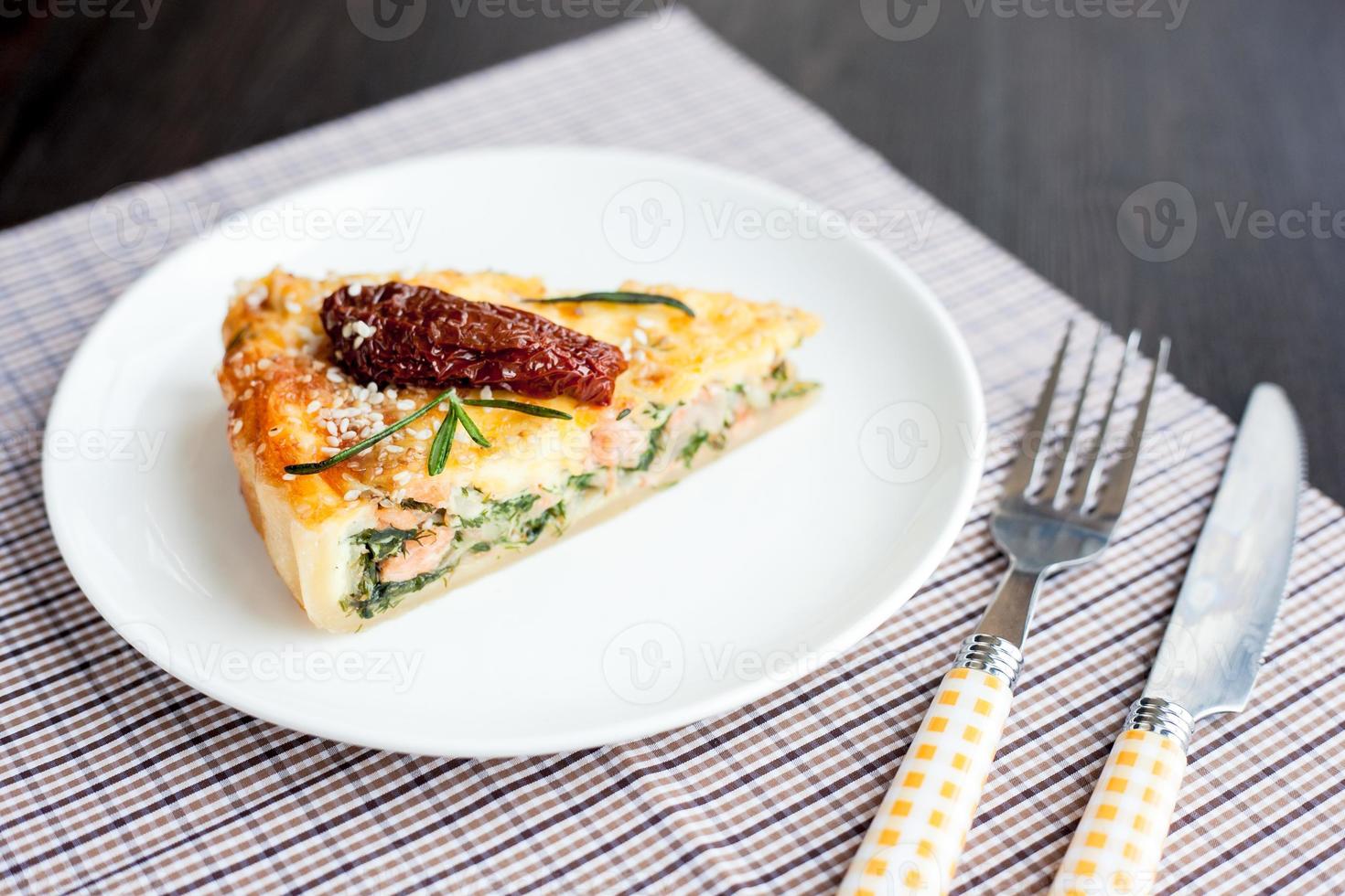 Piece of pie with spinach and fish salmon photo
