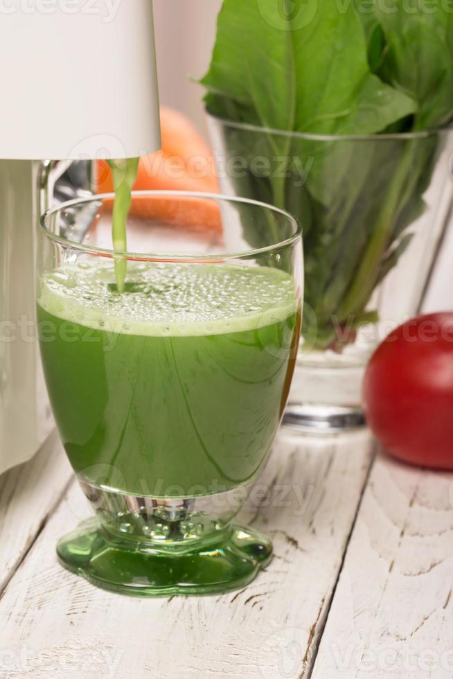 Spinach juice from juicers pouring into a glass 772143 Stock Photo at