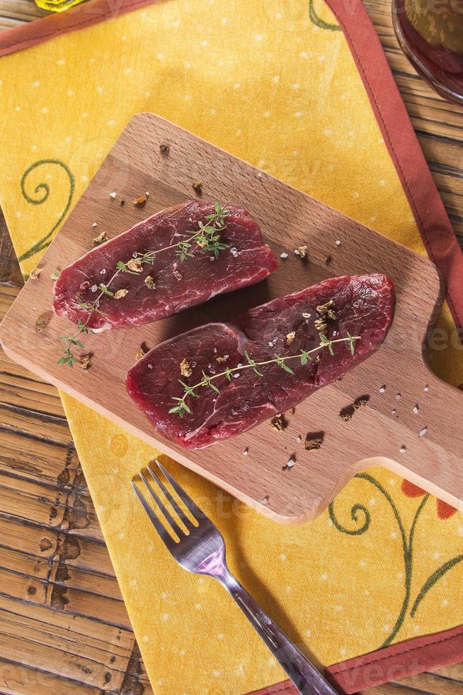 Raw beef tenderloin with spices photo