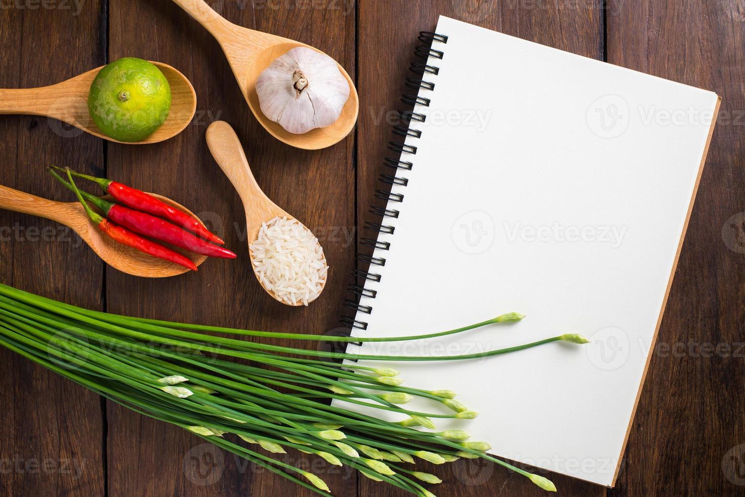 Recipe notebook, rice, Red chilli, garlic and lemon on wood photo
