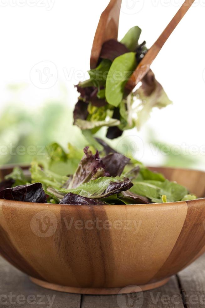 mixing vegetables on wooden bowl photo