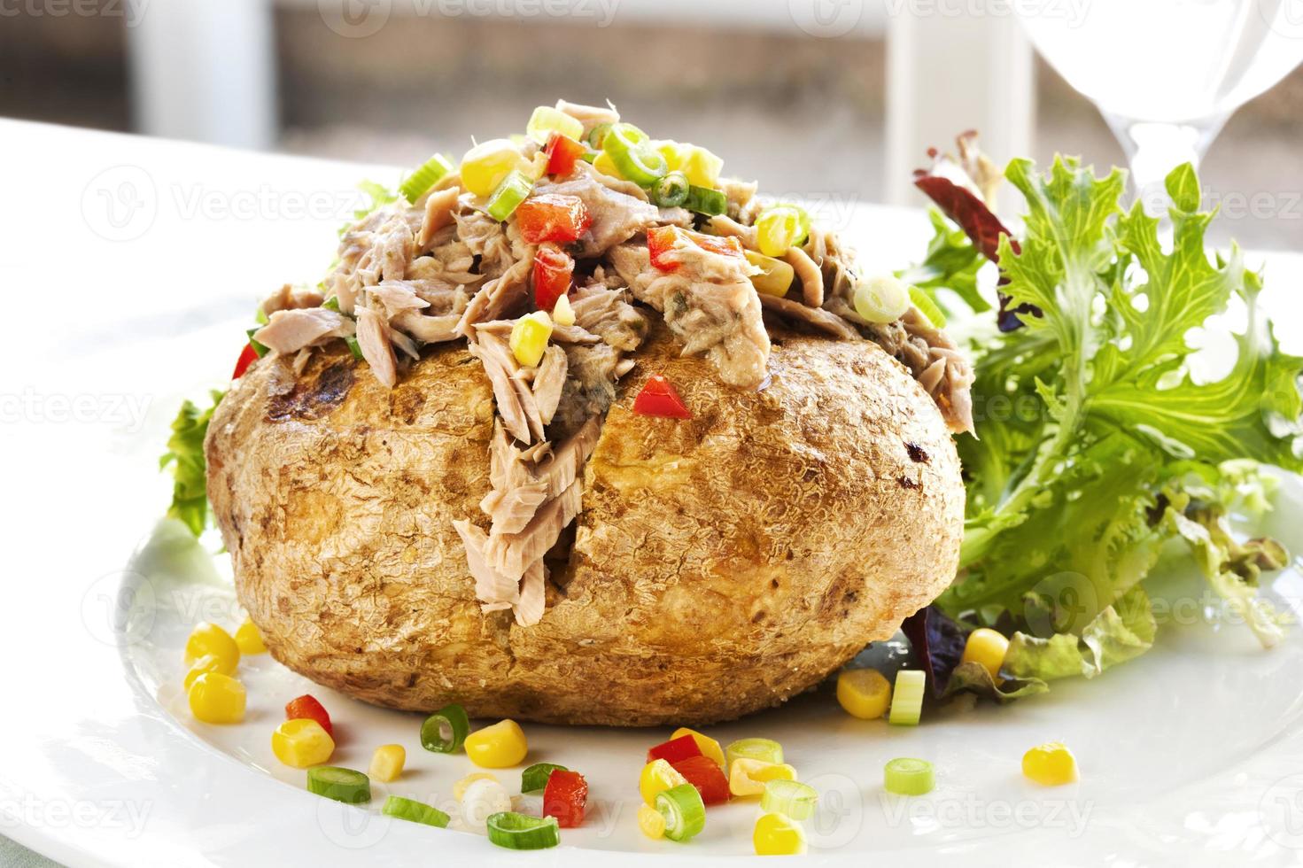 Serving of baked potato with tuna and vegetable filling photo