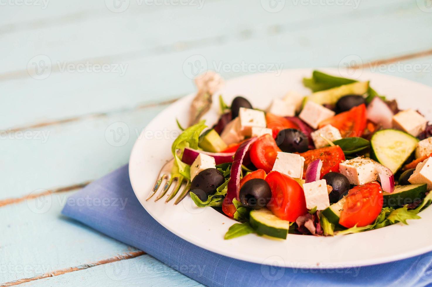Greek salad on wooden background photo