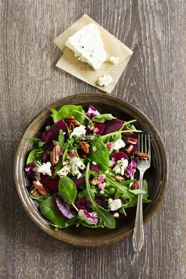 Salad with beet, blue cheese, nuts and vinaigrette. photo
