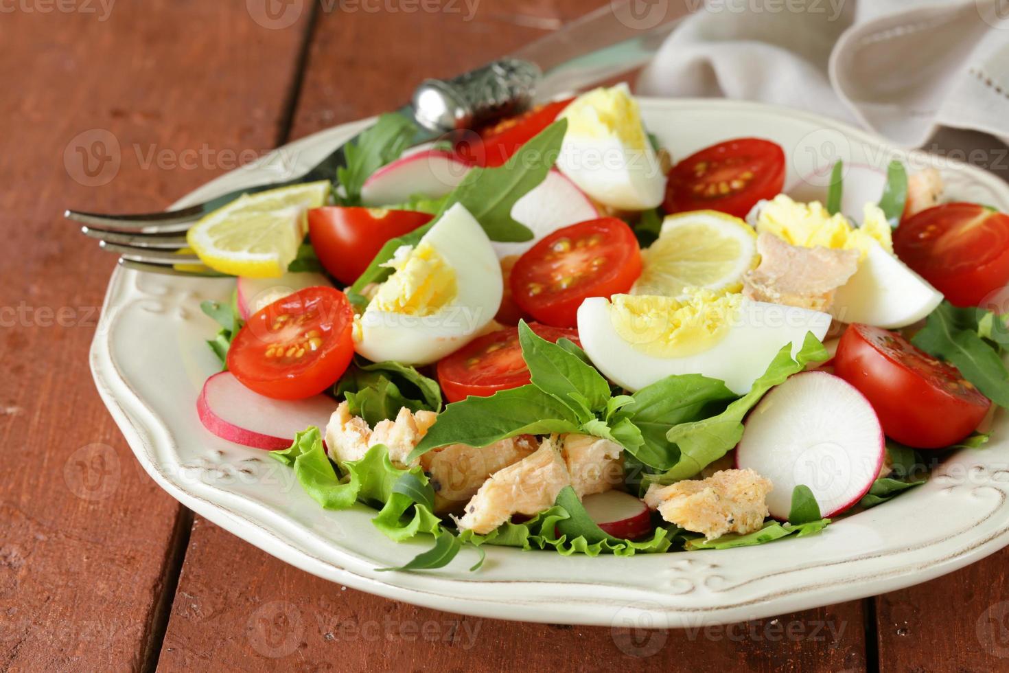 fresh green salad with salmon and tomatoes photo