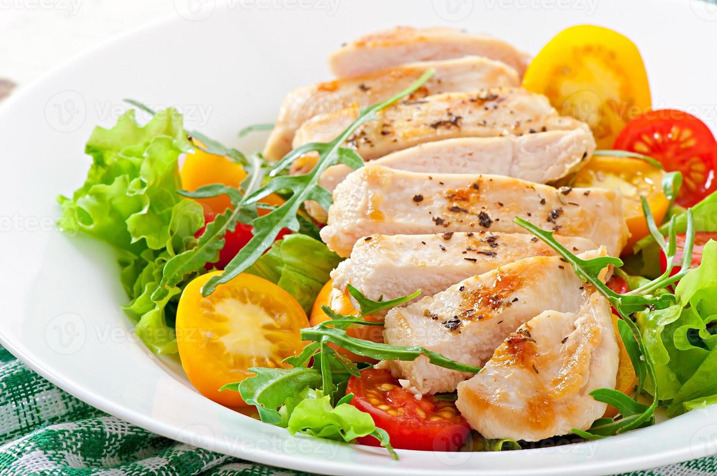 Grilled chicken breasts and fresh salad photo