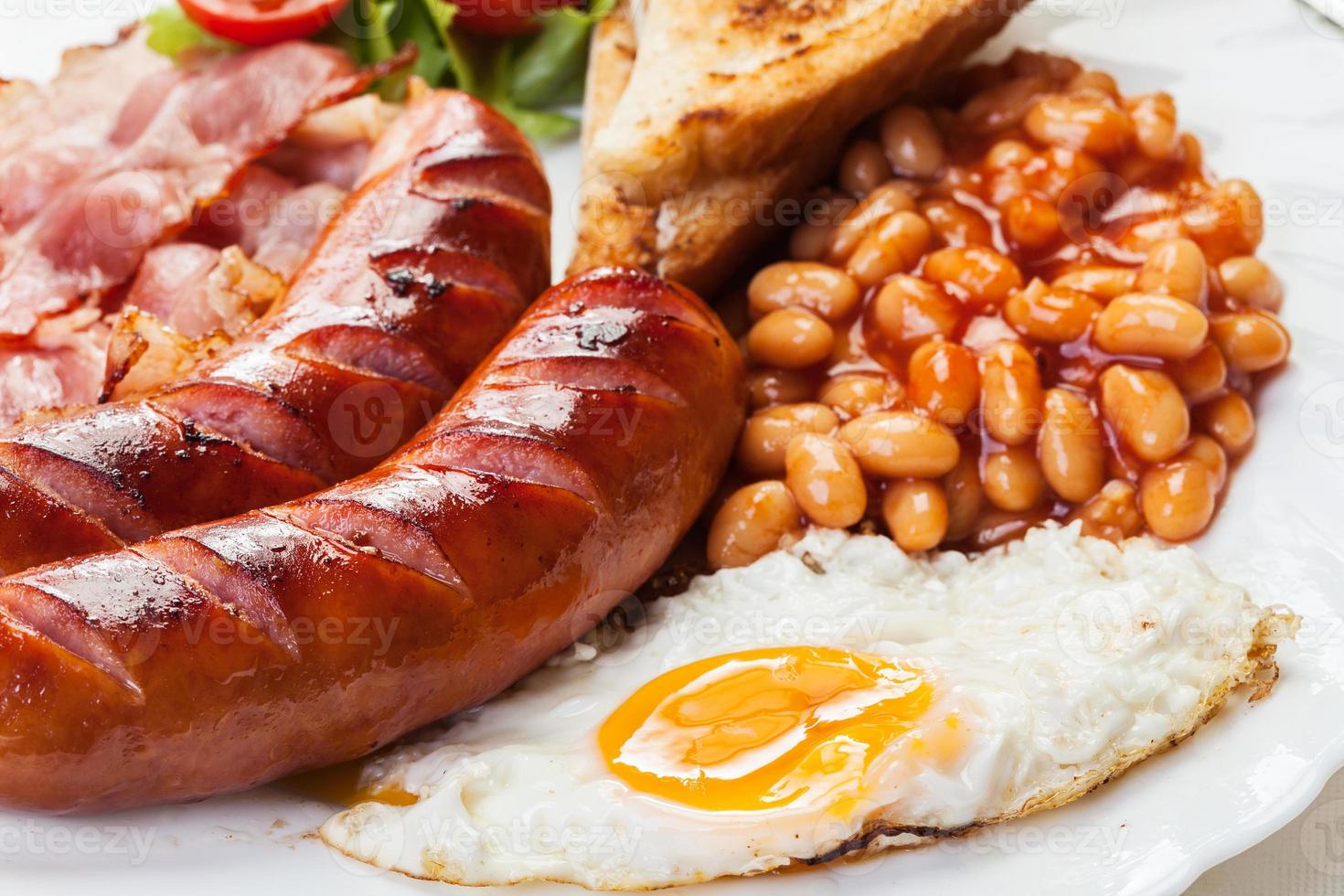 Full English breakfast with bacon, sausage, egg and baked beans photo