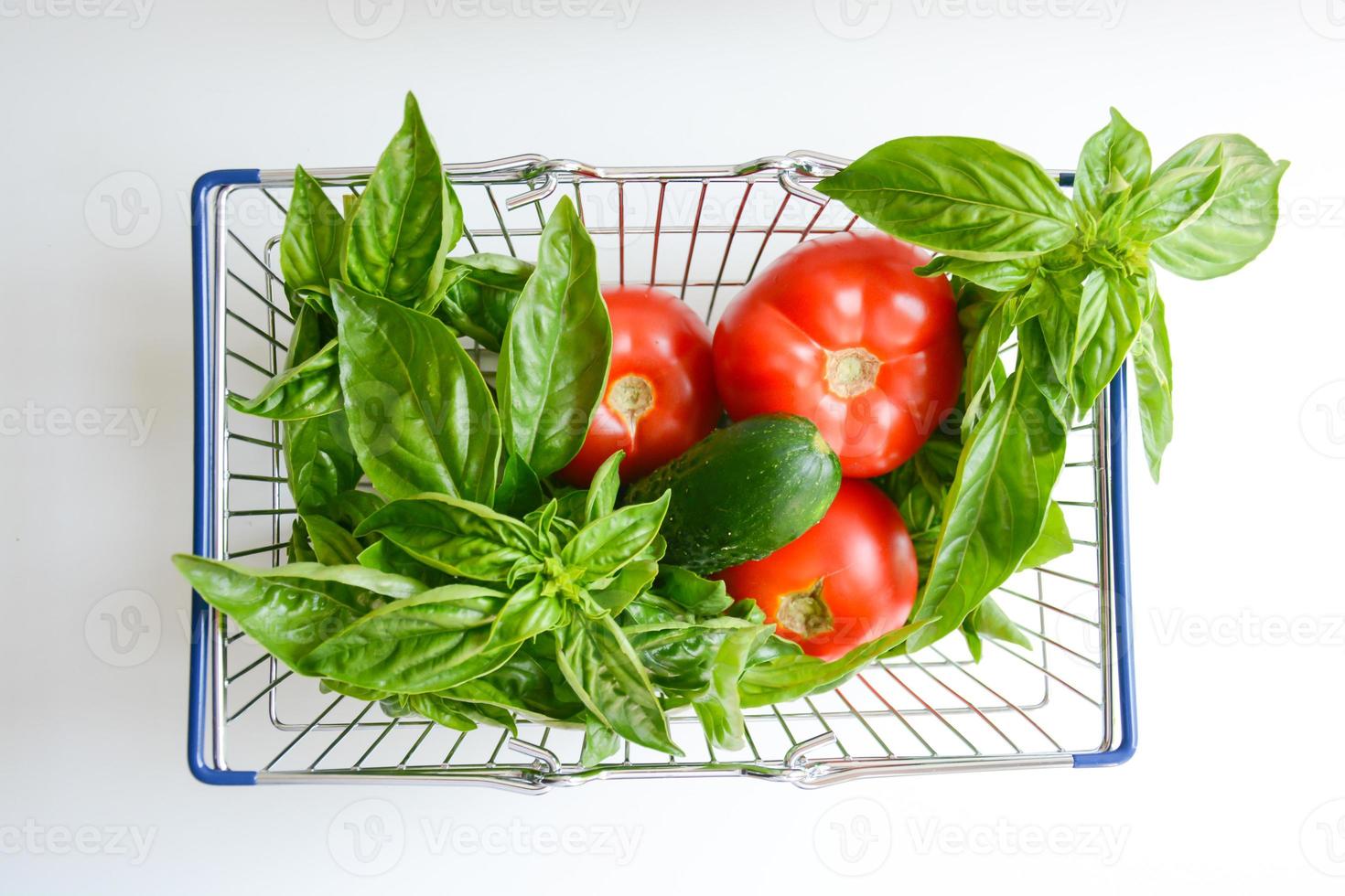 Fresh Vegetables in shopping cart isolated on white background photo