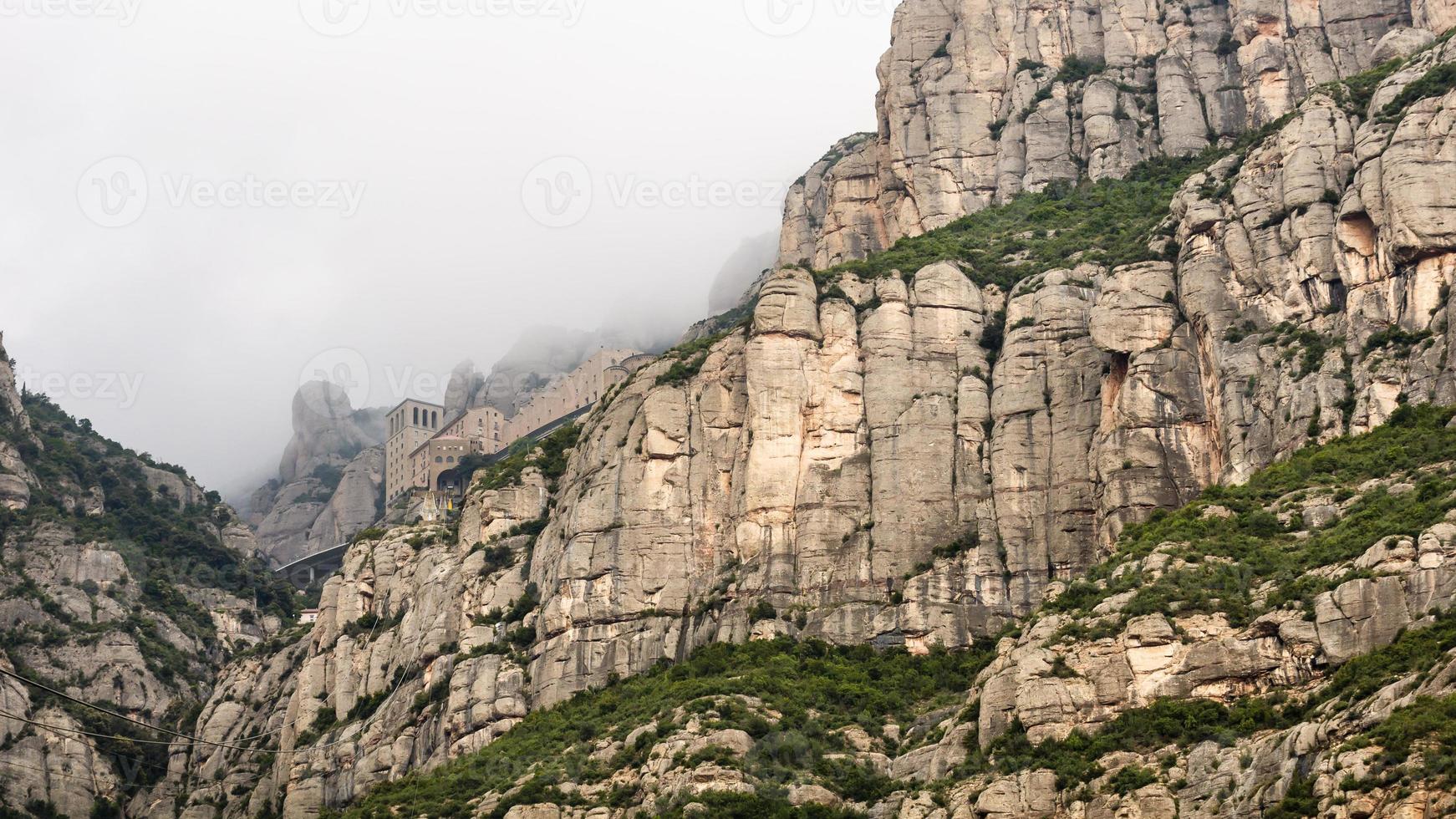 Santa Maria de Montserrat monastery emerging from the fog photo
