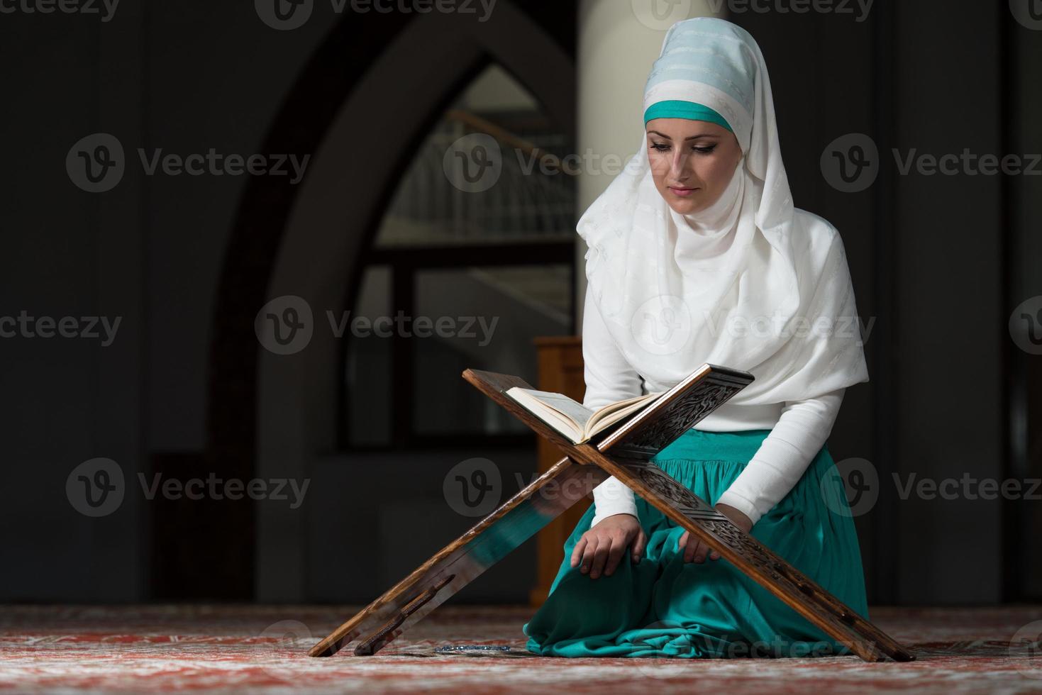 Muslim Woman Reading The Koran photo