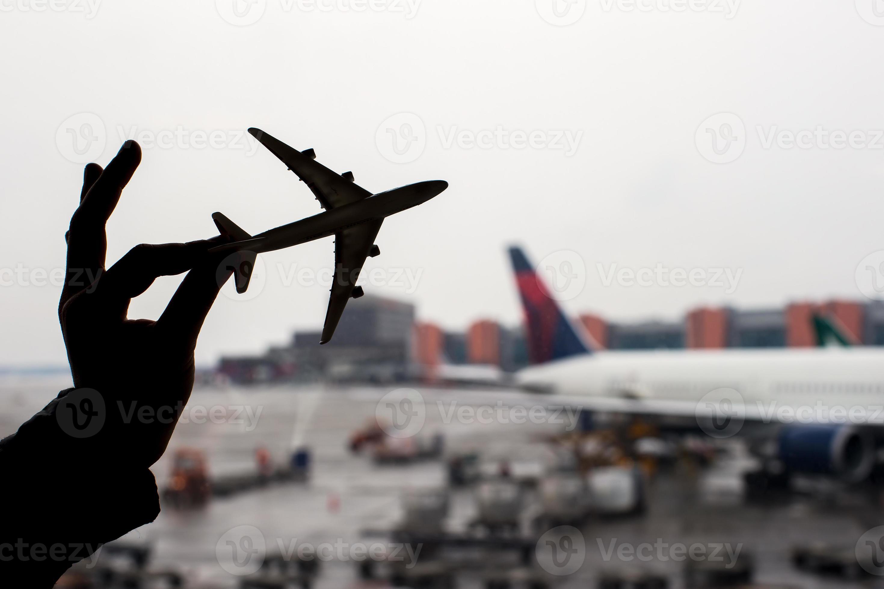 Silhouette of a small airplane model on airport background photo