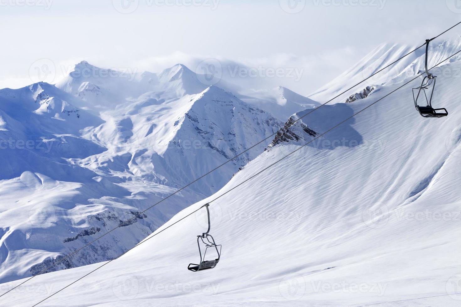 Chair lifts and off-piste slope in haze photo