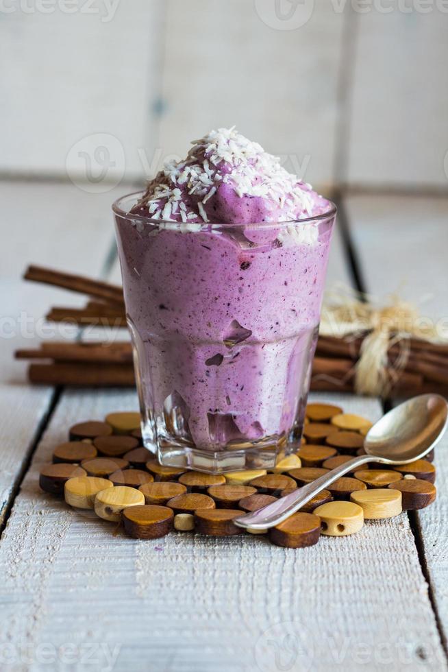 blueberry banana smoothie with coconut in a glass photo