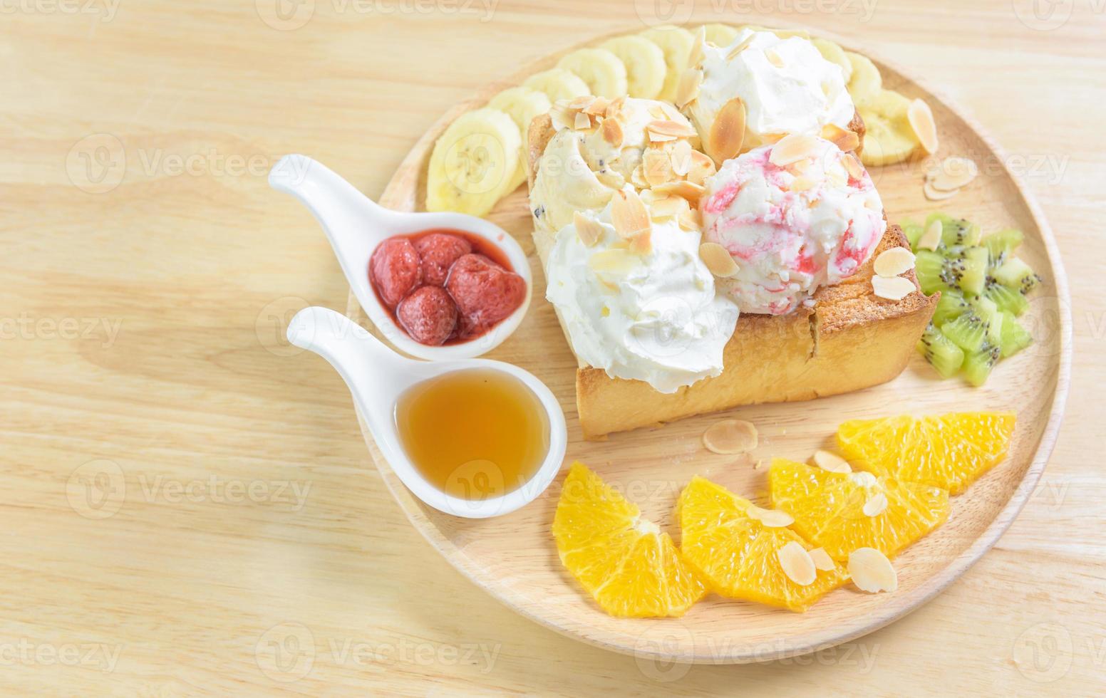 honey toast strawberry with ice cream fruit banana and orange photo