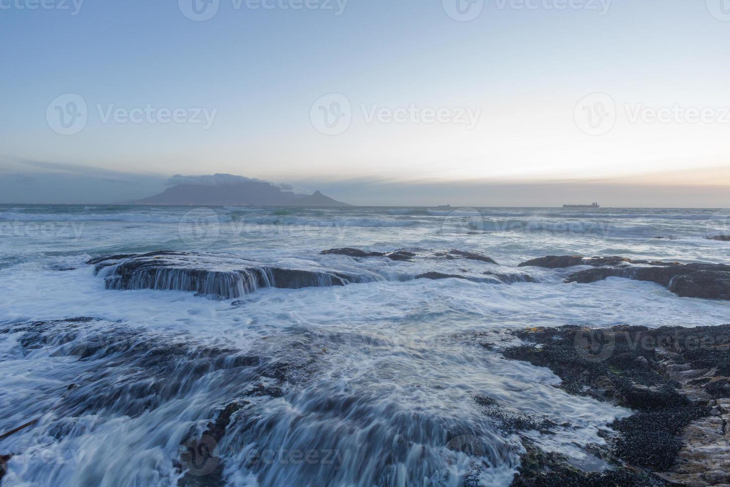 olas rompiendo sobre rocas foto
