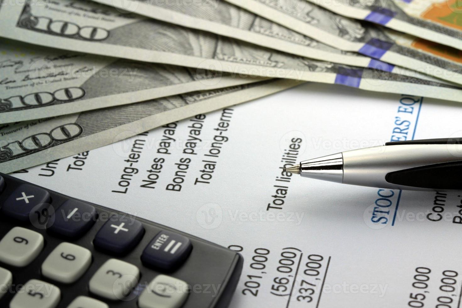 US currency, calculator and financial documents closeup photo