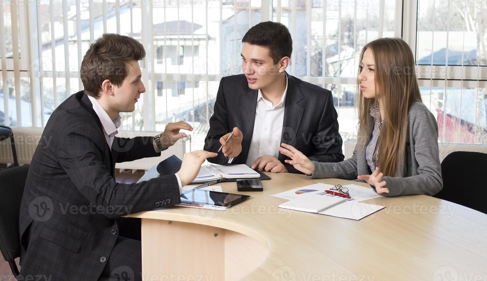 Group of three people having discussion photo