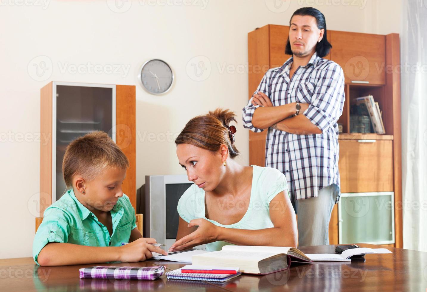 Ordinary family doing homework photo