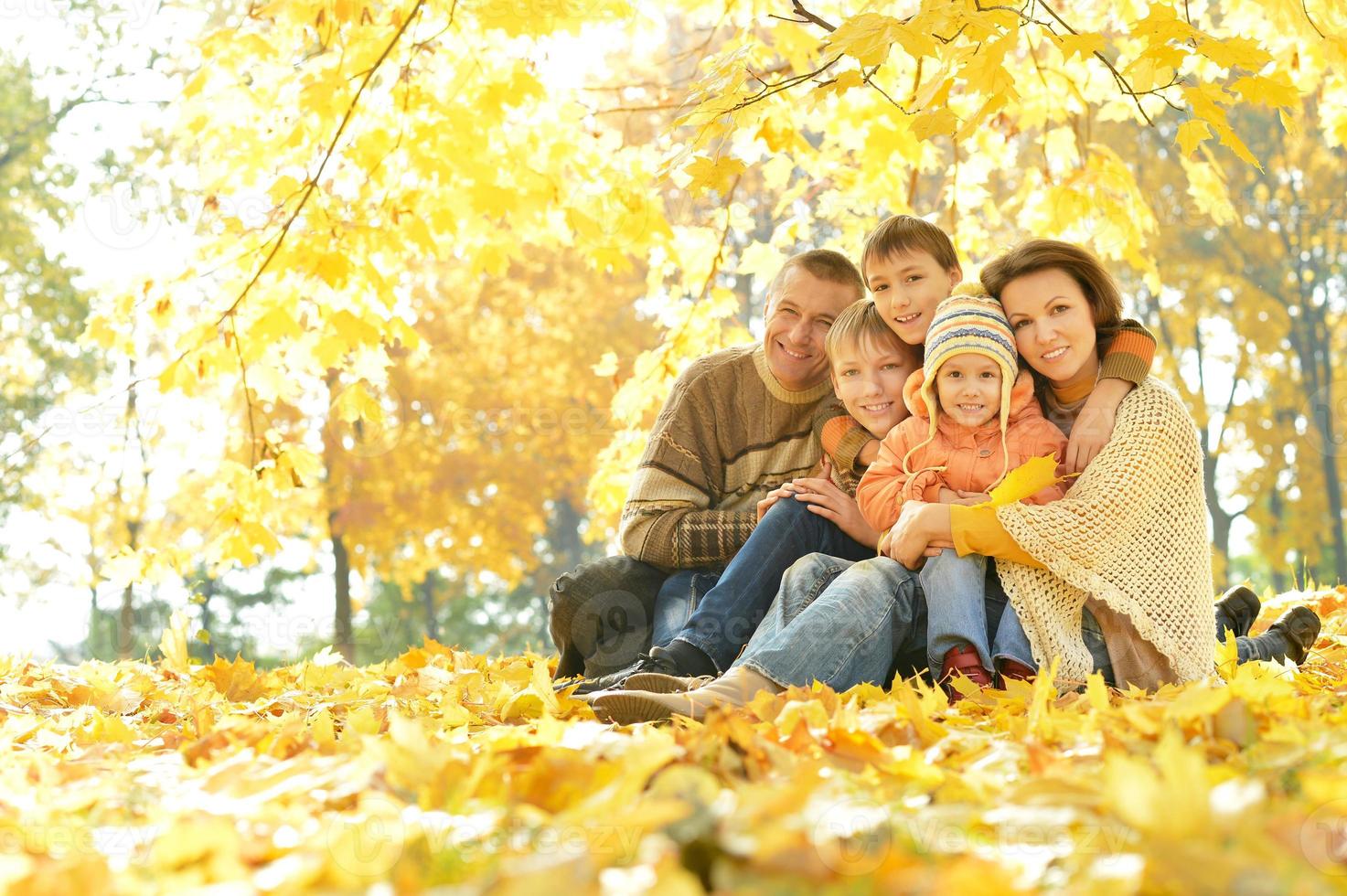 Happy family in autumn forest photo