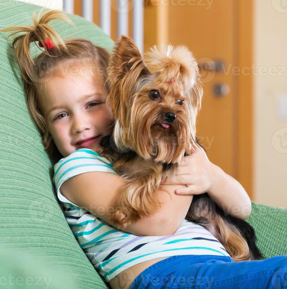 Female child playing with Yorkie photo