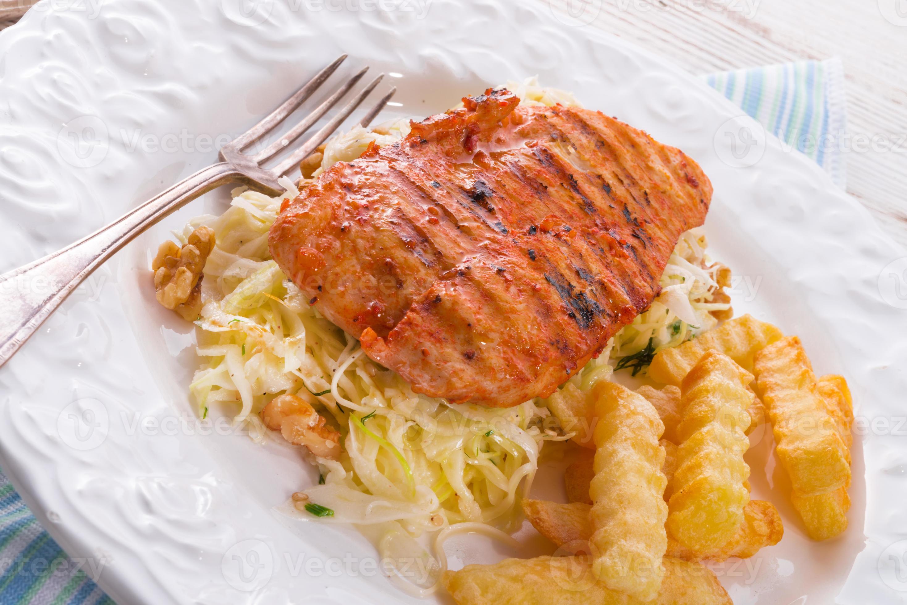 grilled chicken, cabbage salad with nuts and chips 802549 Stock Photo