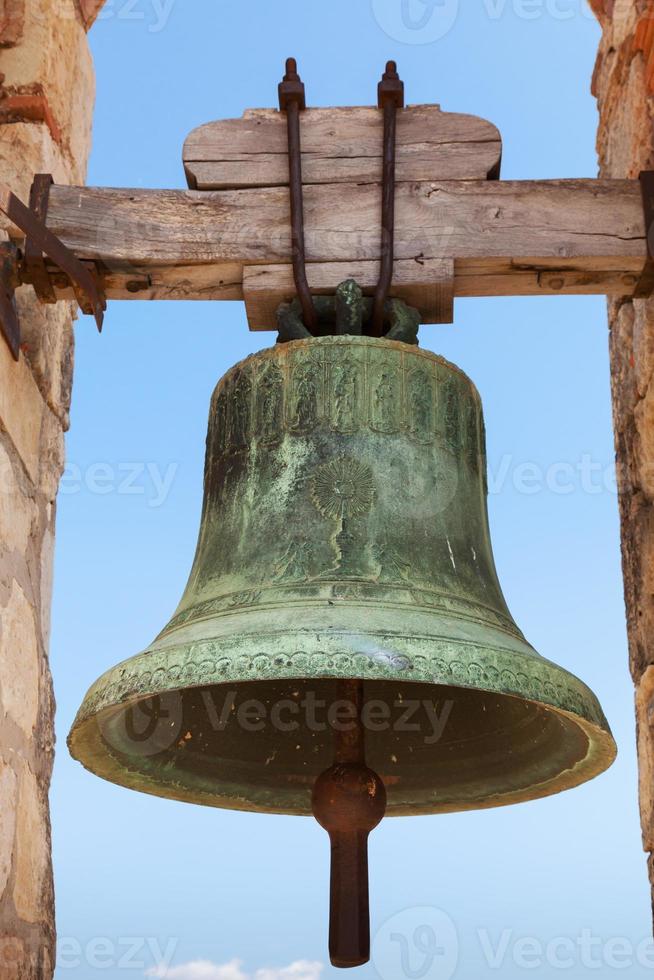Ancient bell in fortress of Calafell, Spain photo