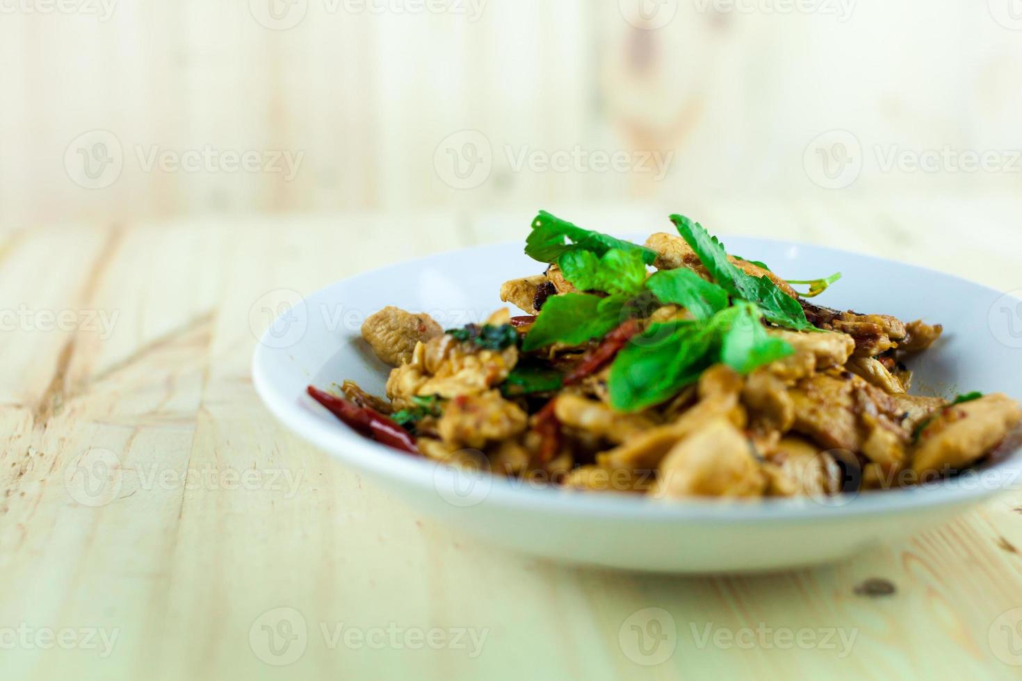 Spicy Thai basil chicken ready to eat on traditional plate photo
