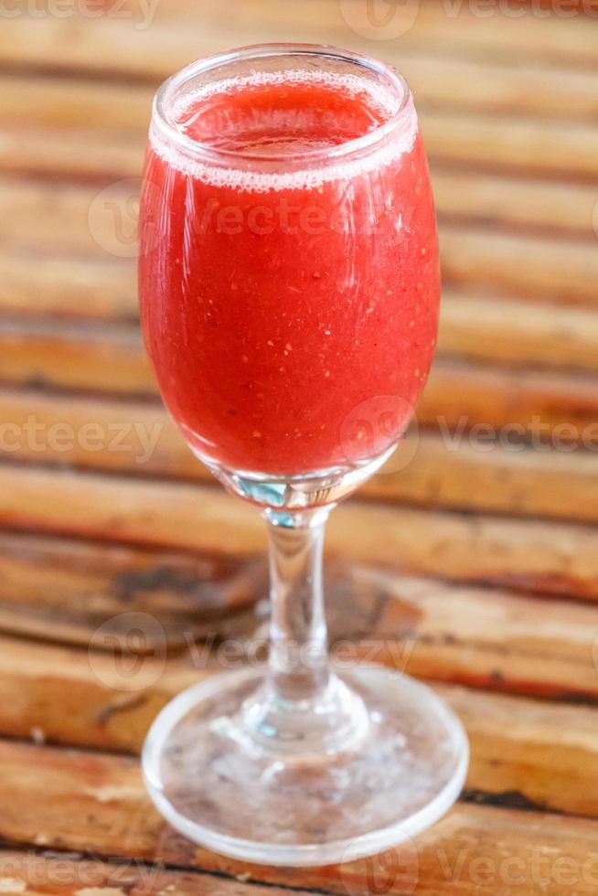 Glass of strawberry smoothie photo