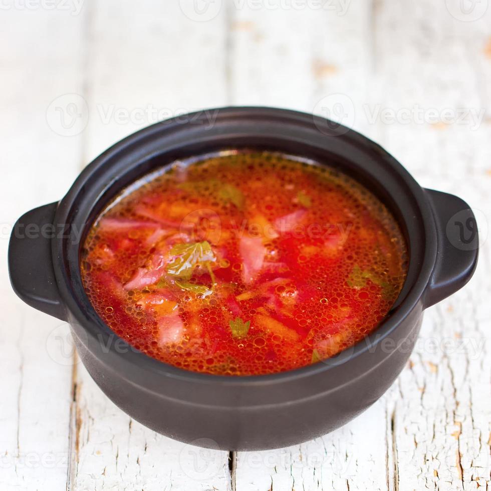 Red borsch. The traditional Ukrainian dish. In a small saucepan photo
