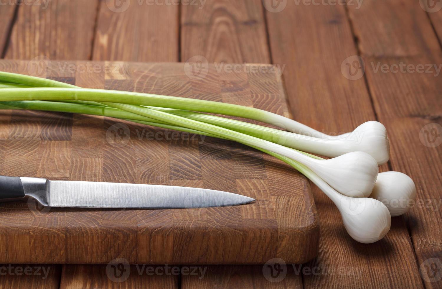 Fresh garlic on chopping board photo