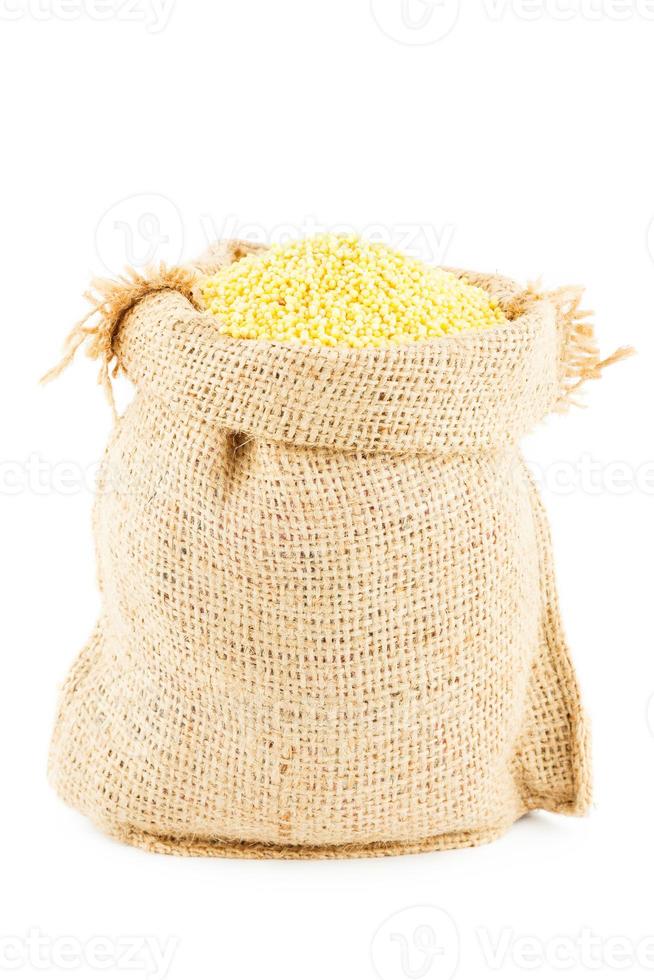Sack is linen filled by yellow millet photo