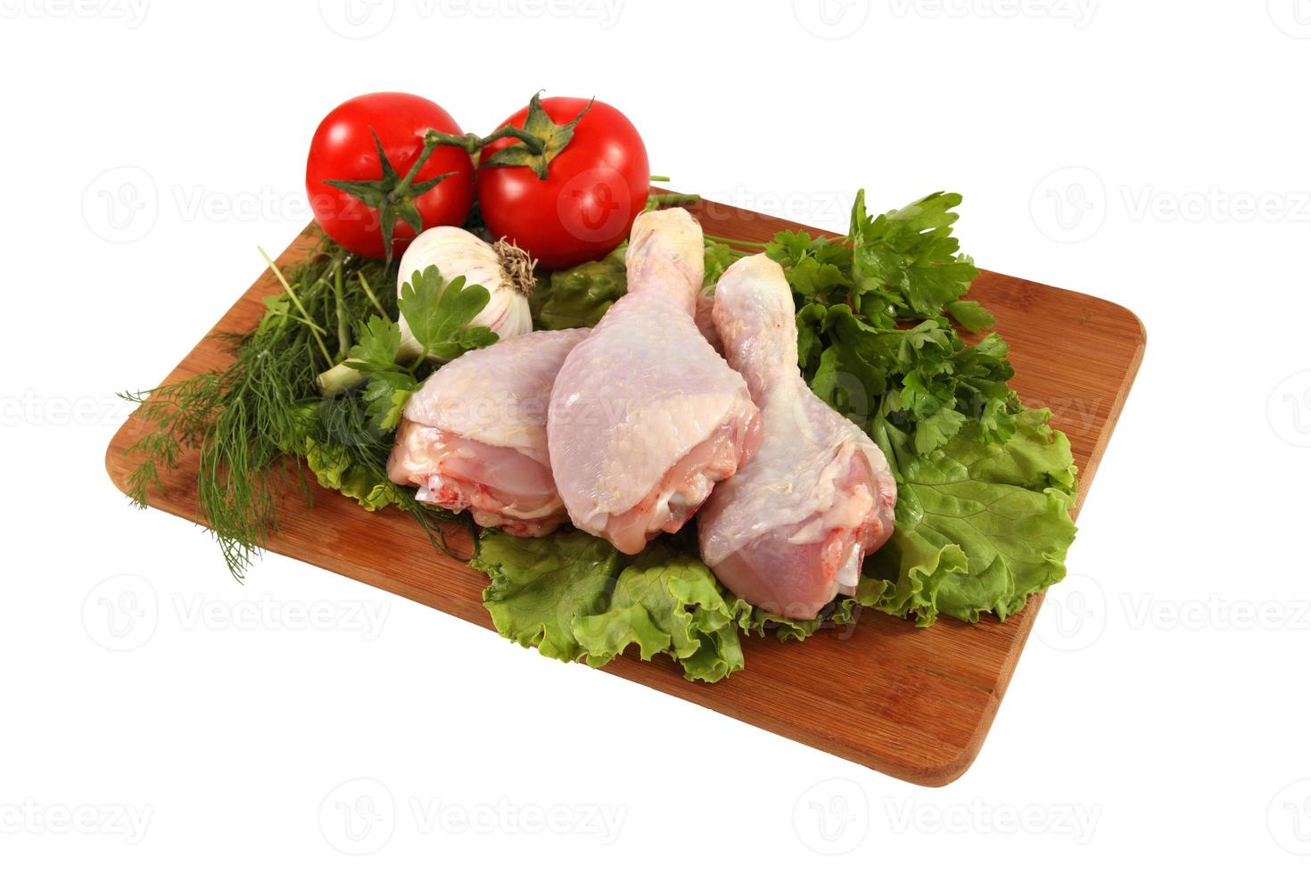 Raw chicken thighs with vegetables photo