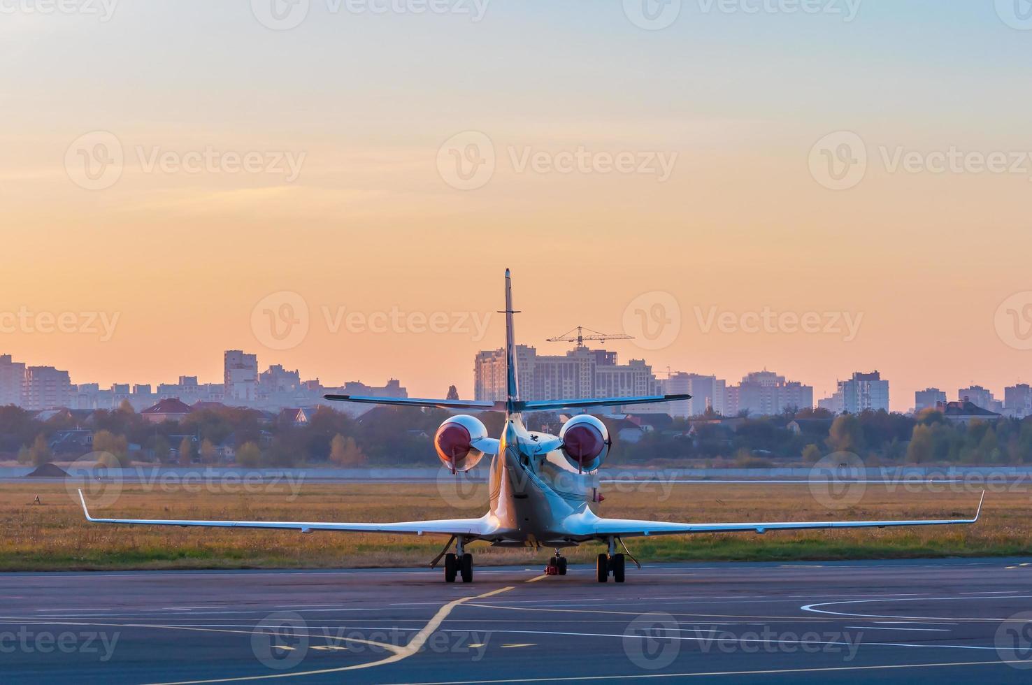 Business jet on the apron for aircraft. The plane against photo