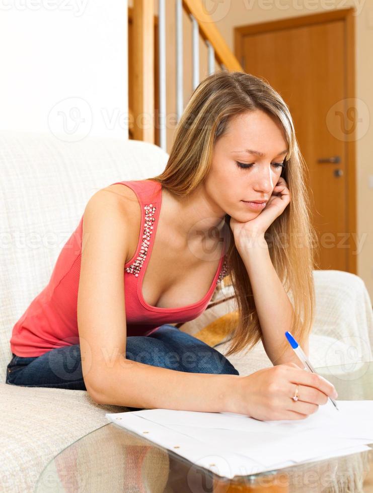 female student studying notes and documents photo