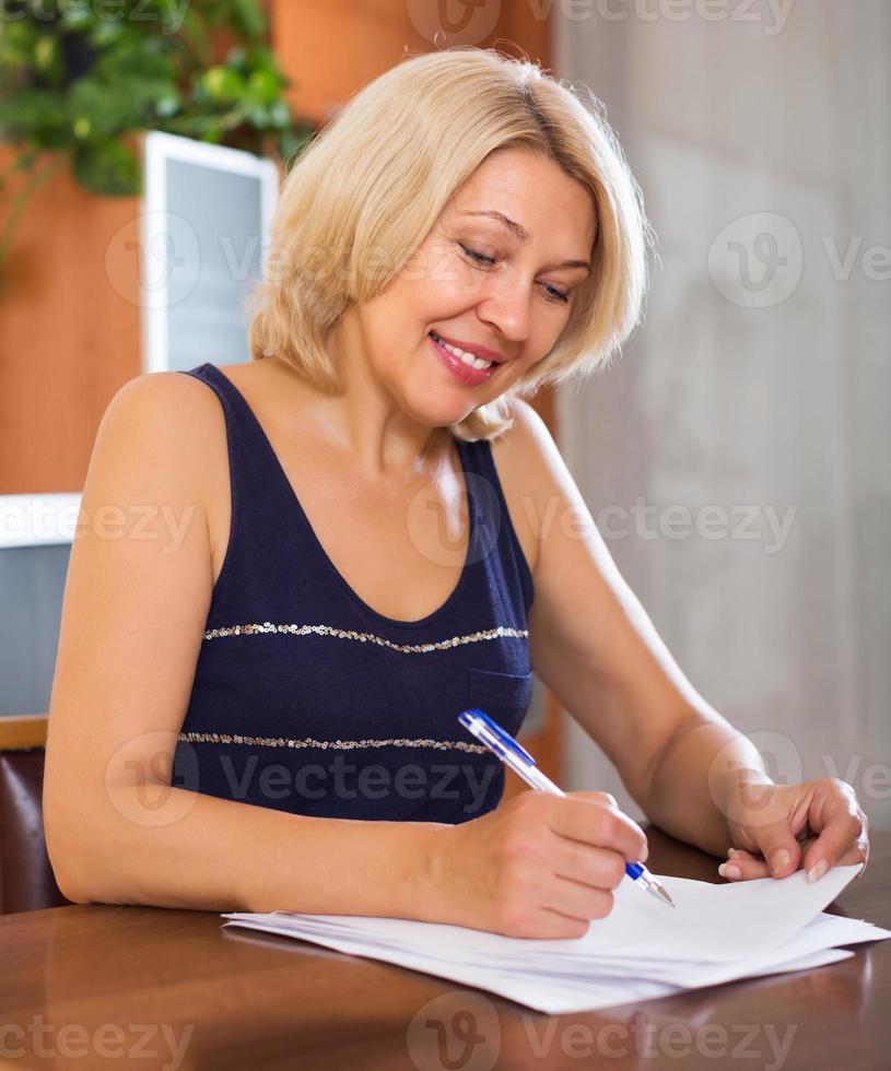 Mature woman with financial documents photo