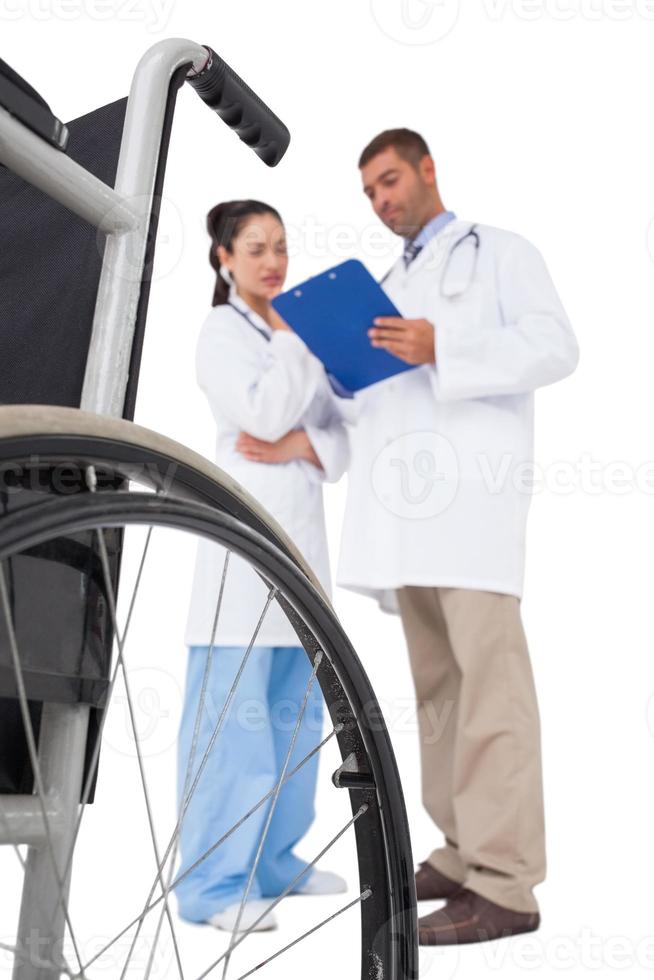 Doctors discussing something on clipboard photo