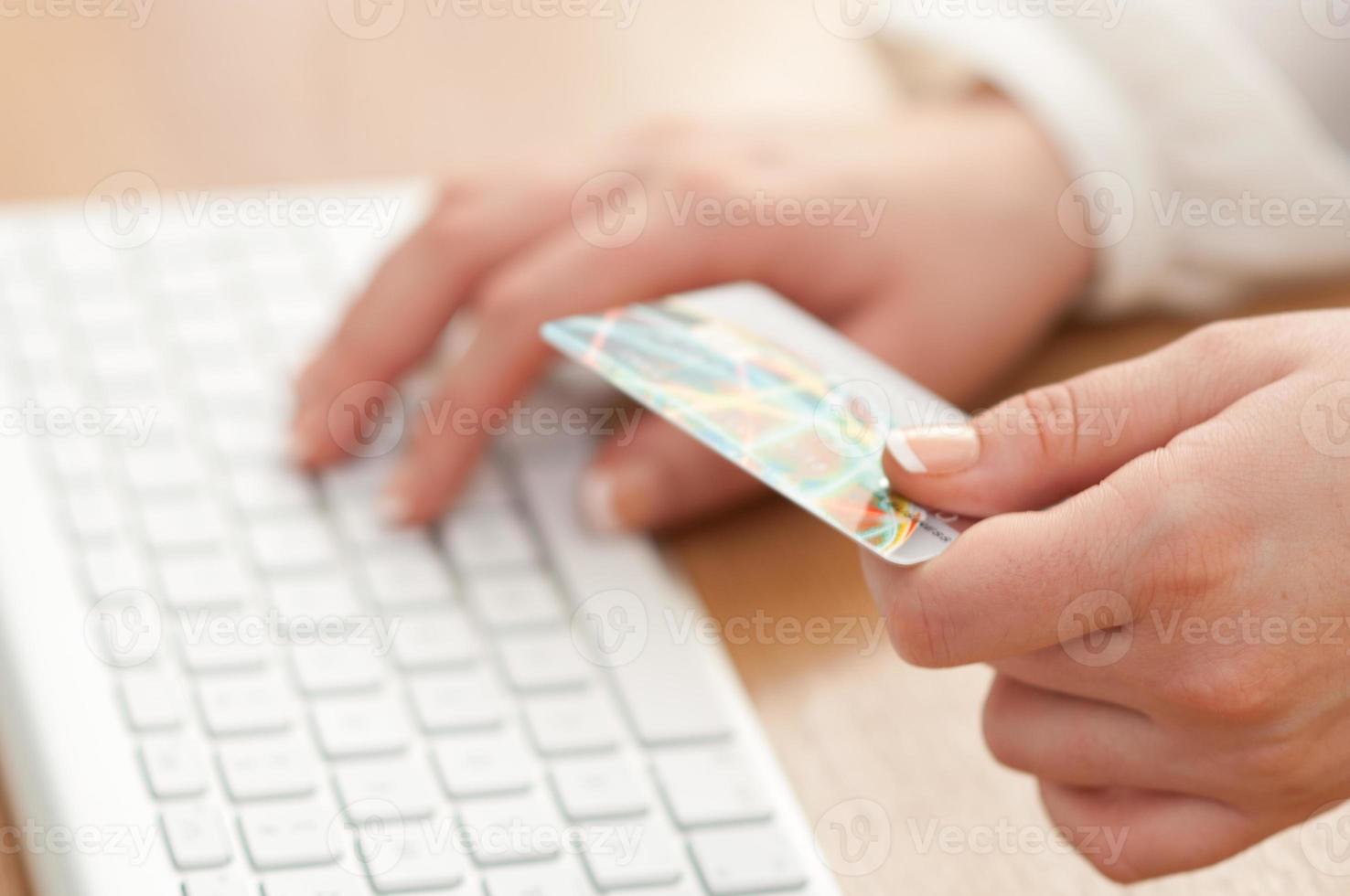 Using computer and credit card for online payment photo