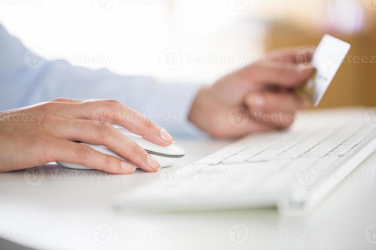 Woman is shopping on the internet with computer photo