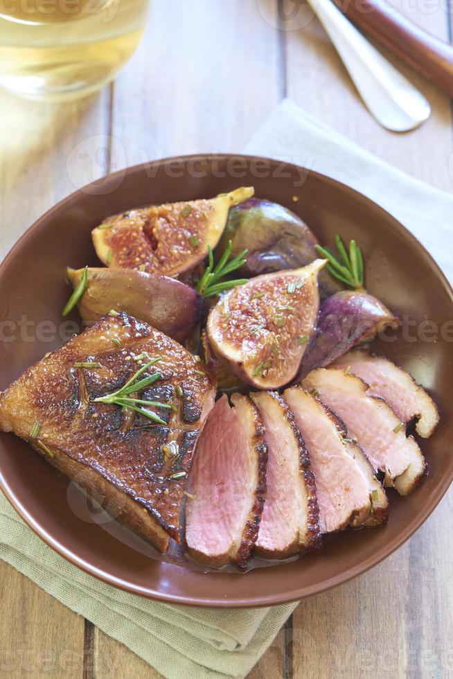 Roasted duck breast with figs in wine sauce photo