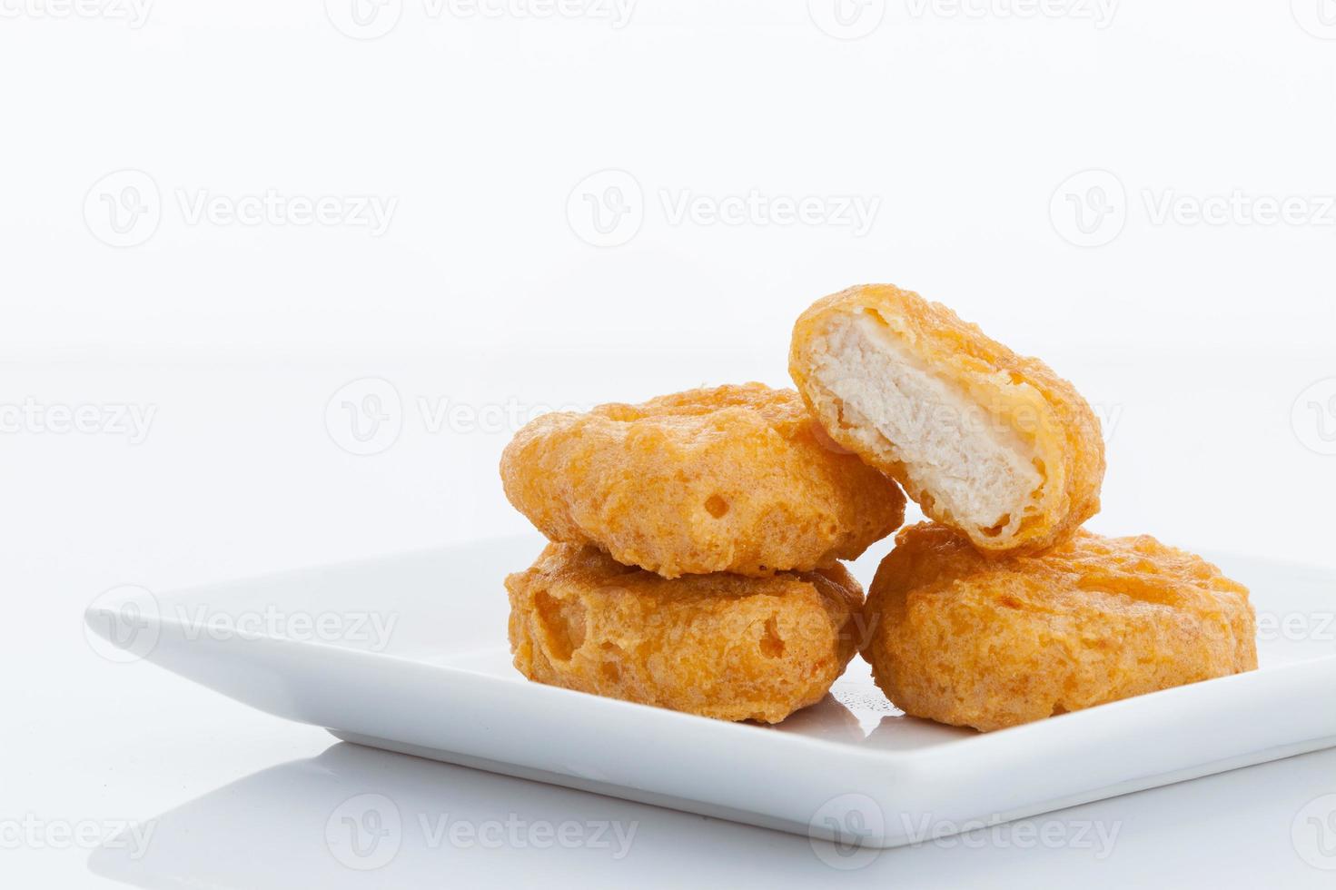 Group of fried chicken nuggets i on white dish photo