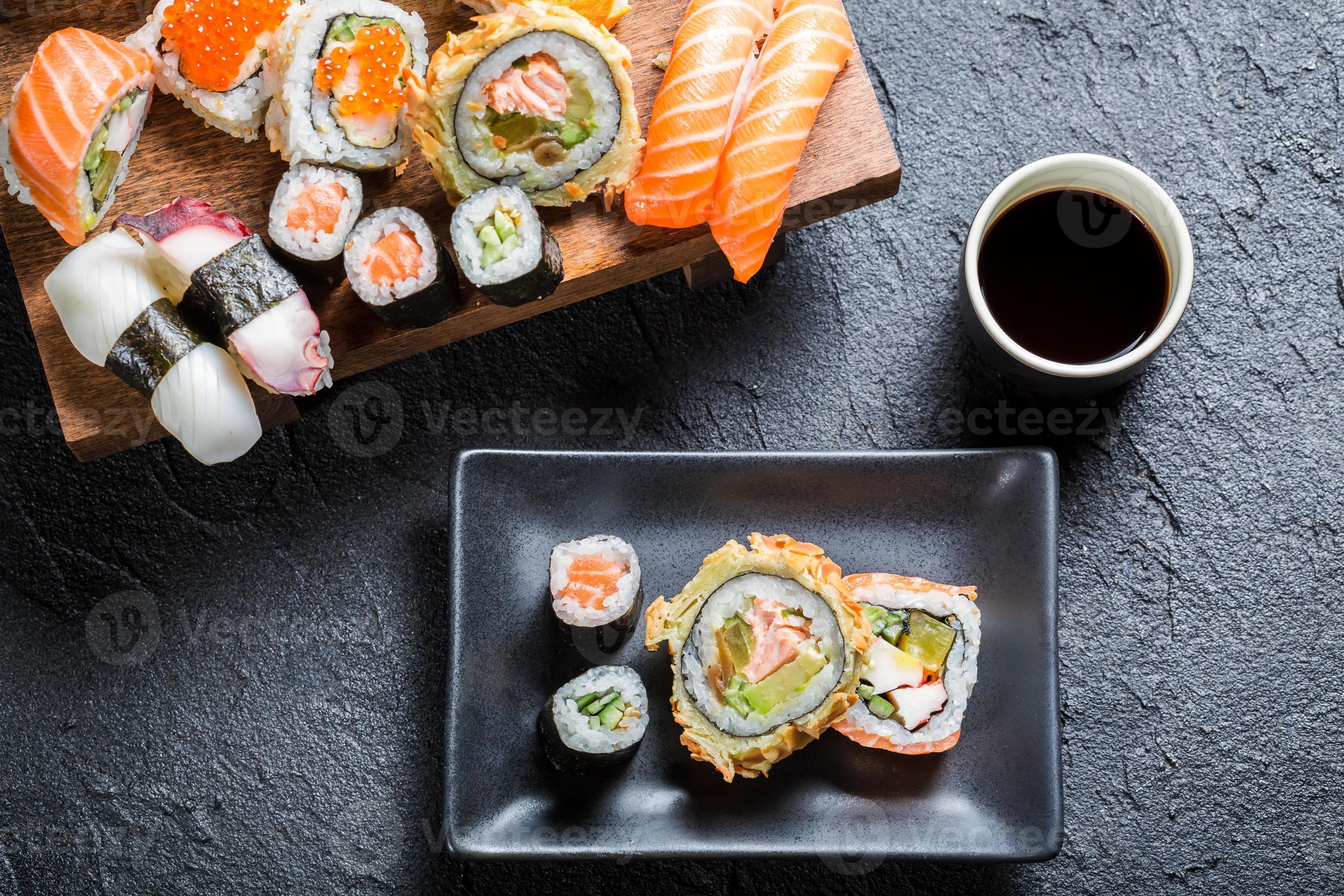 Sushi served with soy sauce on black stone 850767 Stock Photo at Vecteezy