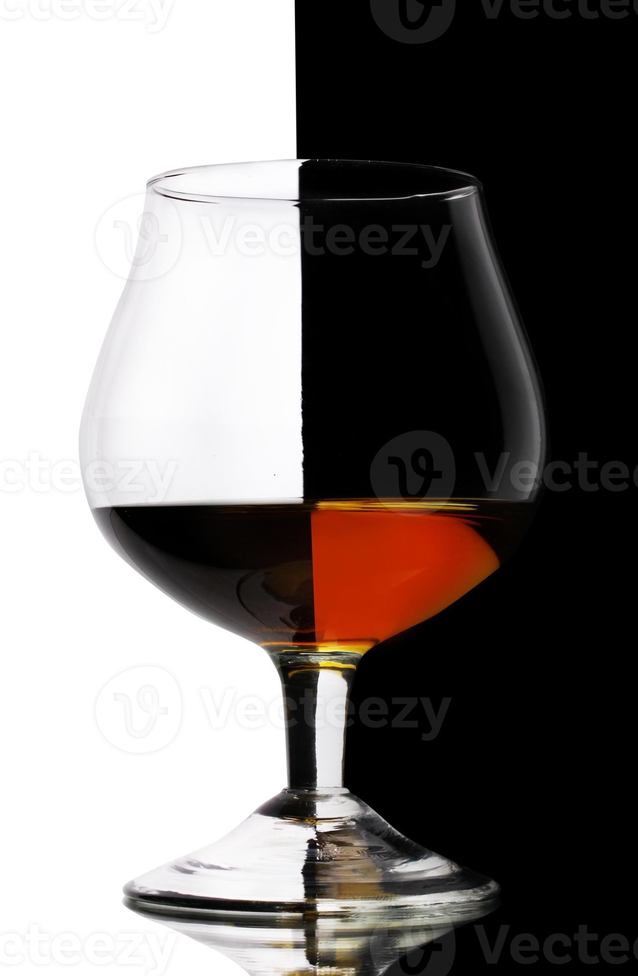 Glass of cognac on white-black background photo