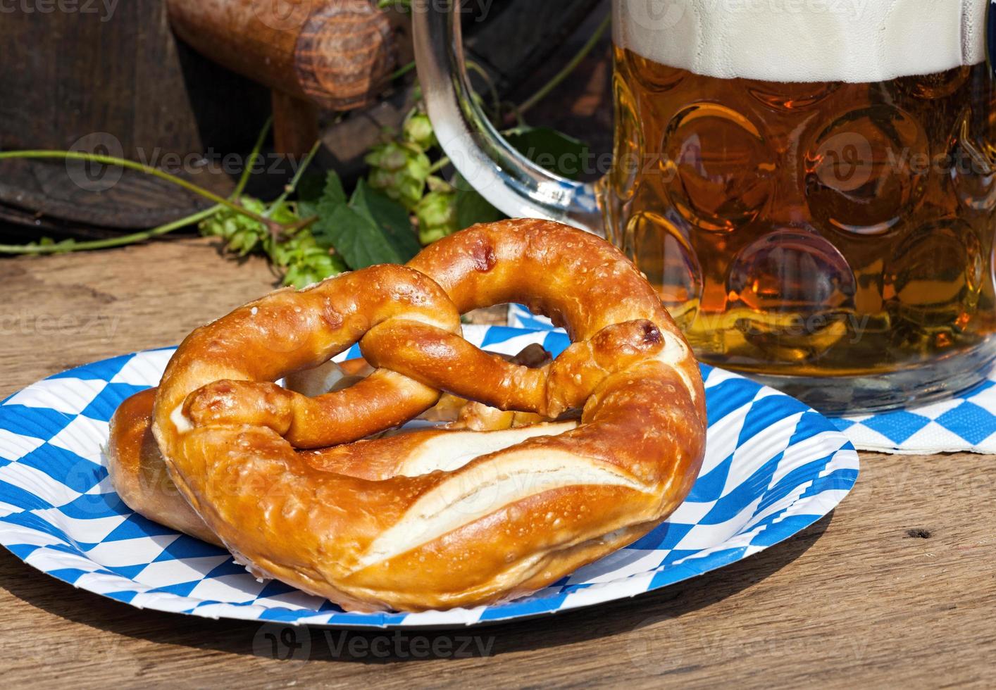 Beer and pretzel on a paper plate photo
