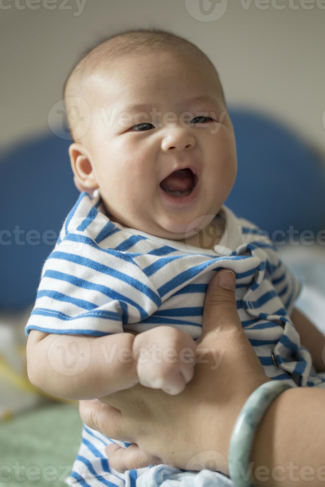 Mother's hands Holding Happy Smiling Asian Baby Boy 855642 Stock Photo at Vecteezy Mother's hands Holding Happy Smiling Asian Baby Boy 855642 Stock Photo at Vecteezy