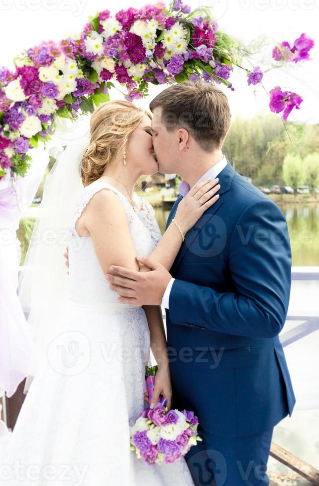 Jovenes Novios Besandose Bajo Arco En La Ceremonia De La Boda 855845 Foto De Stock En Vecteezy