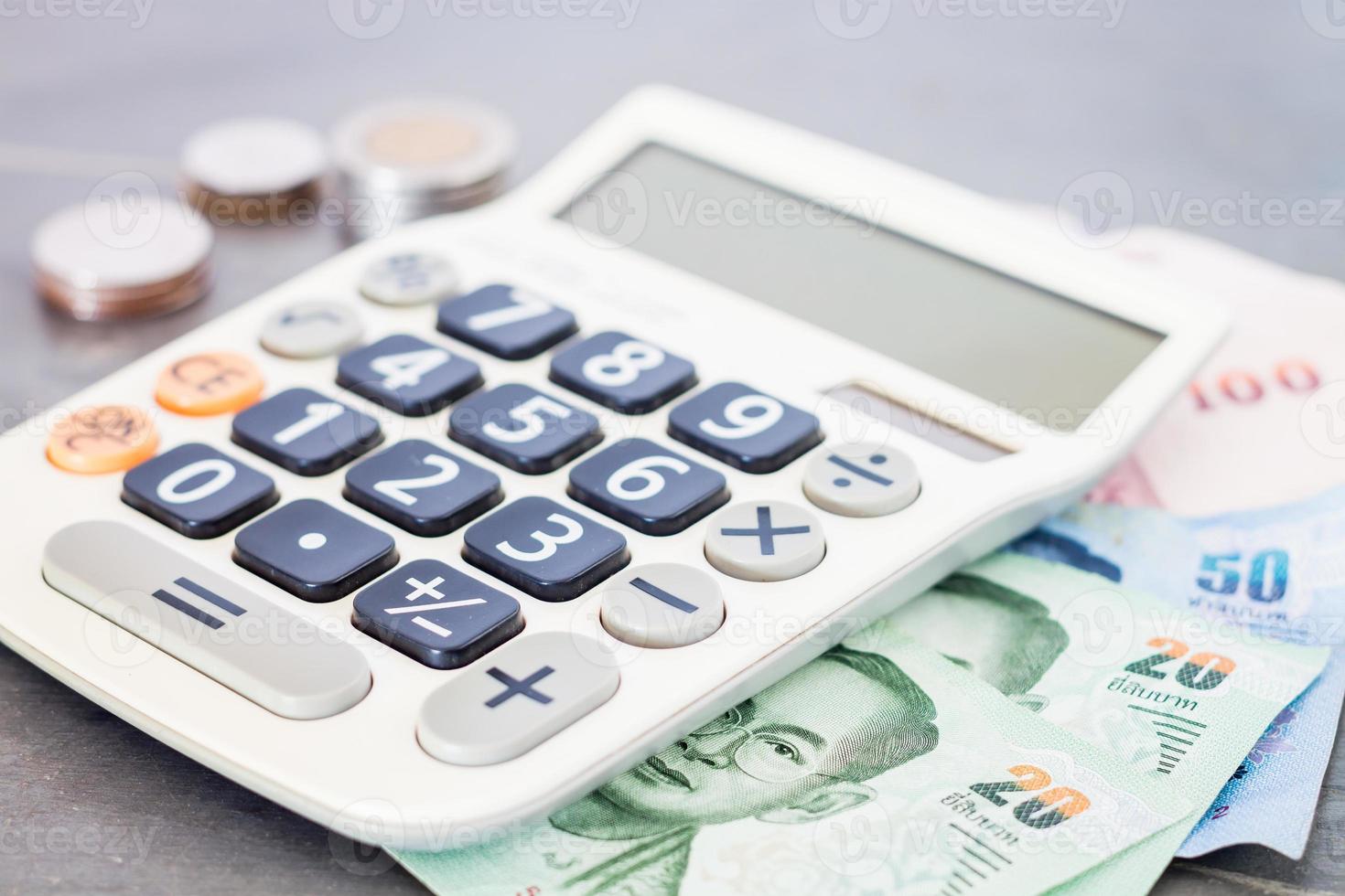 calculadora con dinero en fondo gris foto