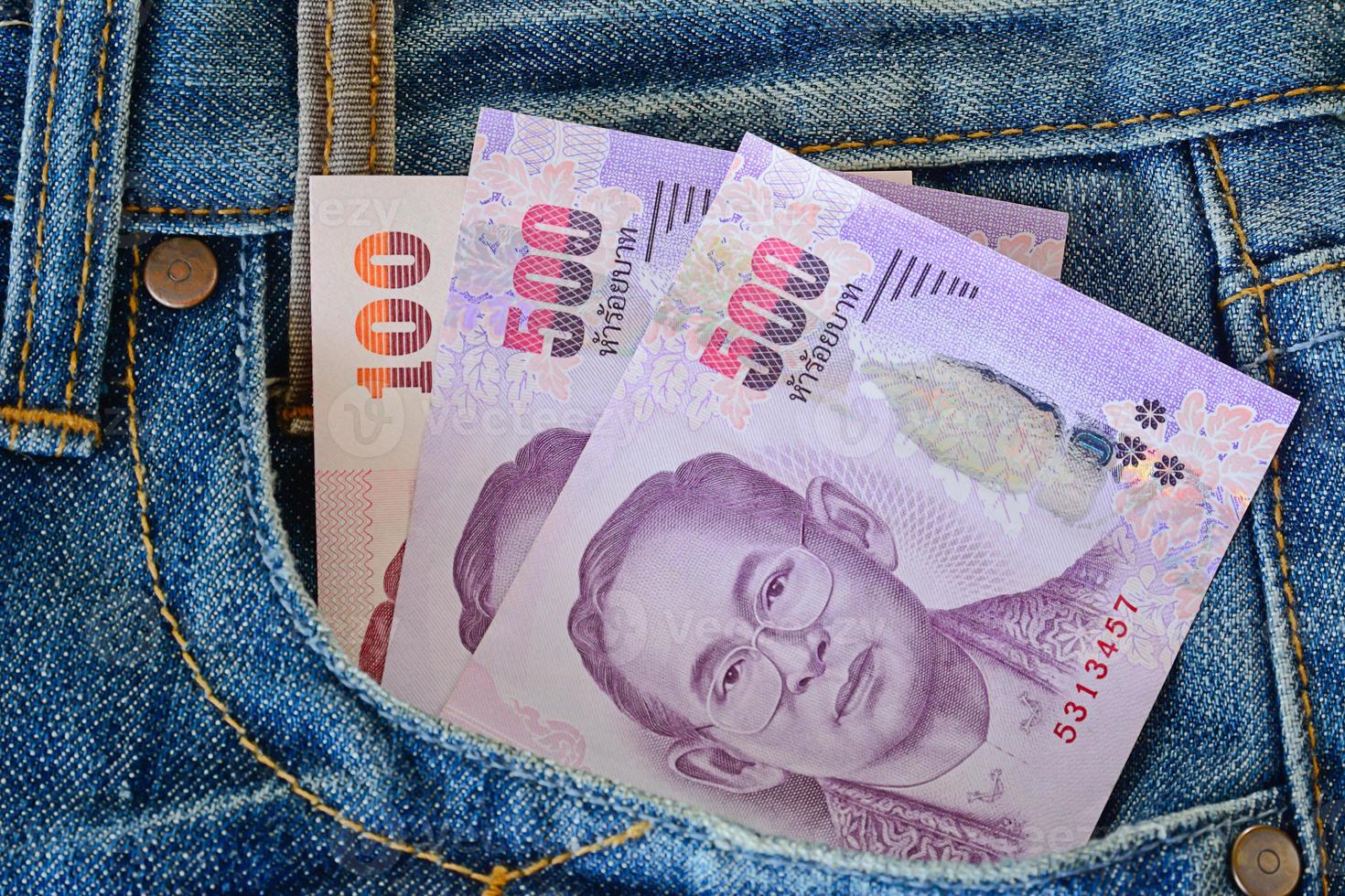 500 and 100 banknotes in men' s blue  jeans pocket photo