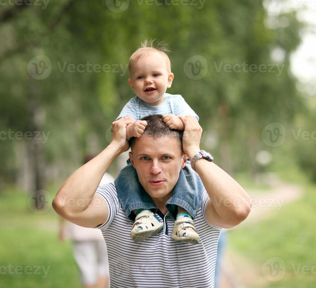little boy playing in the park with dad photo