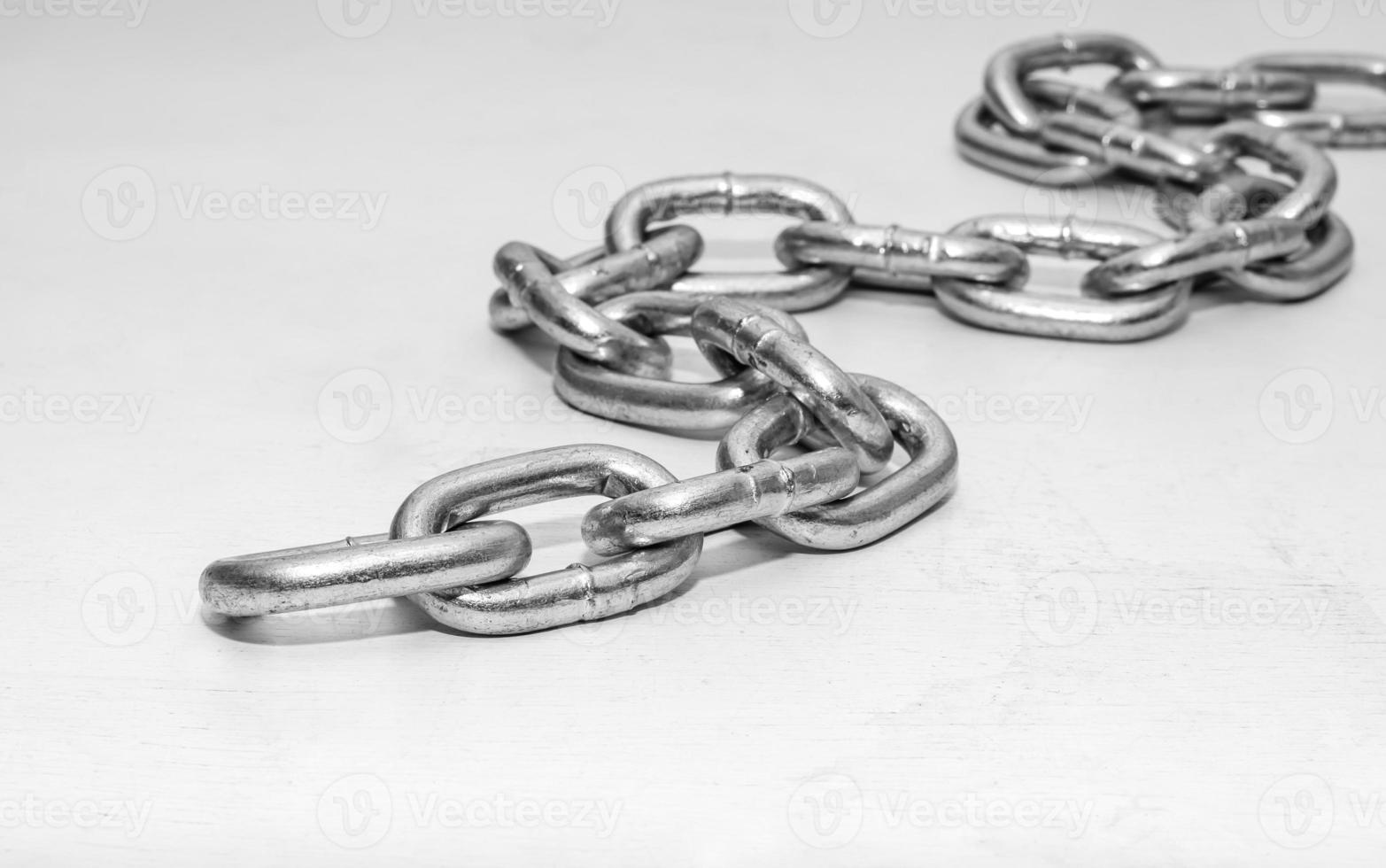 metal chain folded in a heap on white photo